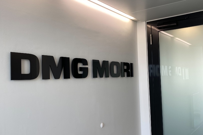 The DMG Mori sign on a white wall