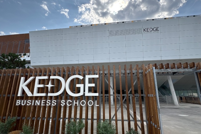 The KEDGE Business School sign outside the campus under a bright sky