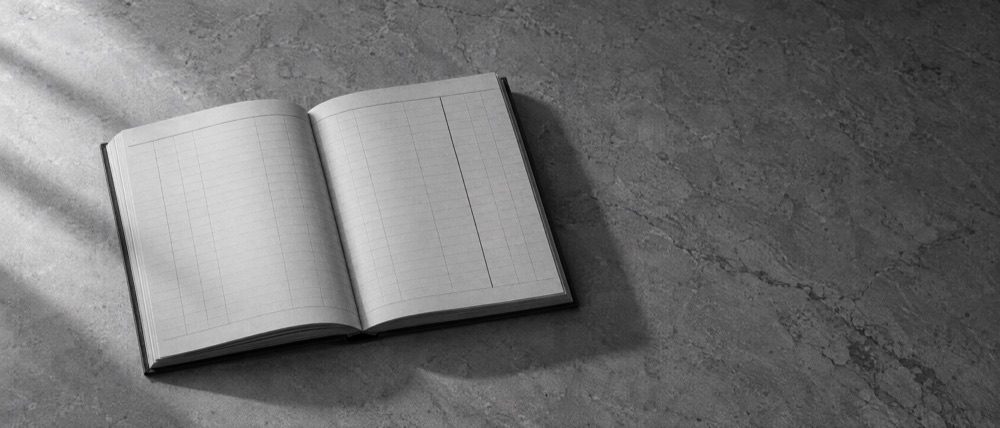 Photograph, greyscale: an open ledger with entirely blank columns and one ruled line drawn through the empty column